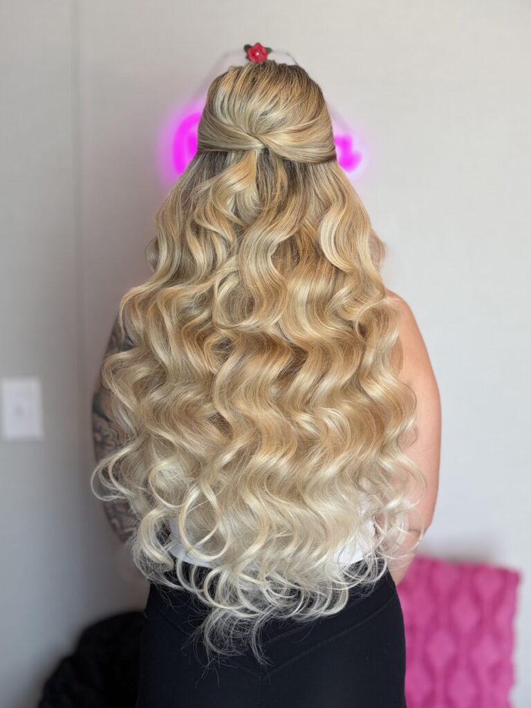 Bridal model with a blonde half-up half-down style with fluffy curls and face framing. Styled by Jaya Ronquillo at the Belleza Bridal studio in Ann Arbor Michigan.