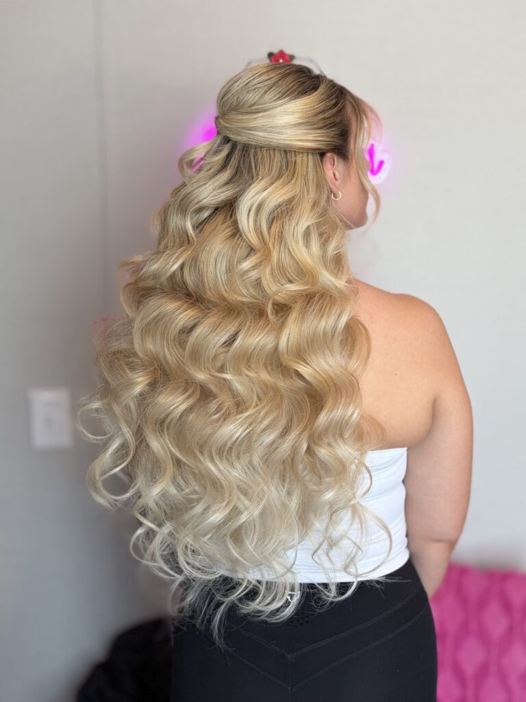 Bridal model with a blonde half-up half-down style with fluffy curls and face framing. Styled by Jaya Ronquillo at the Belleza Bridal studio in Ann Arbor Michigan.