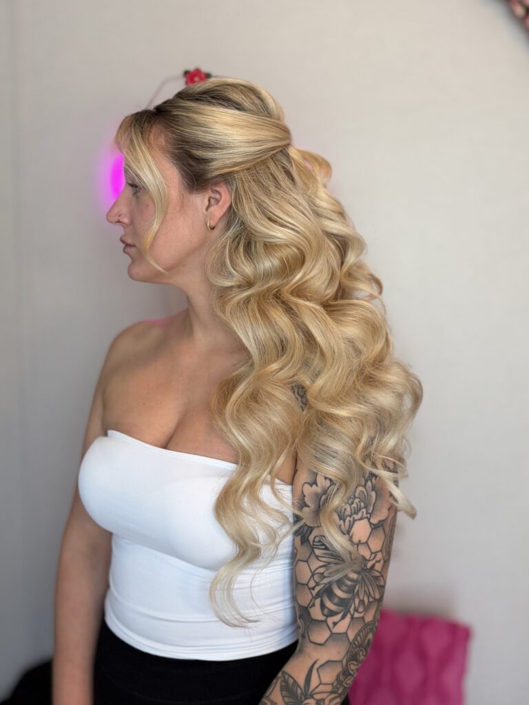 Bridal model with a blonde half-up half-down style with fluffy curls and face framing. Styled by Jaya Ronquillo at the Belleza Bridal studio in Ann Arbor Michigan.