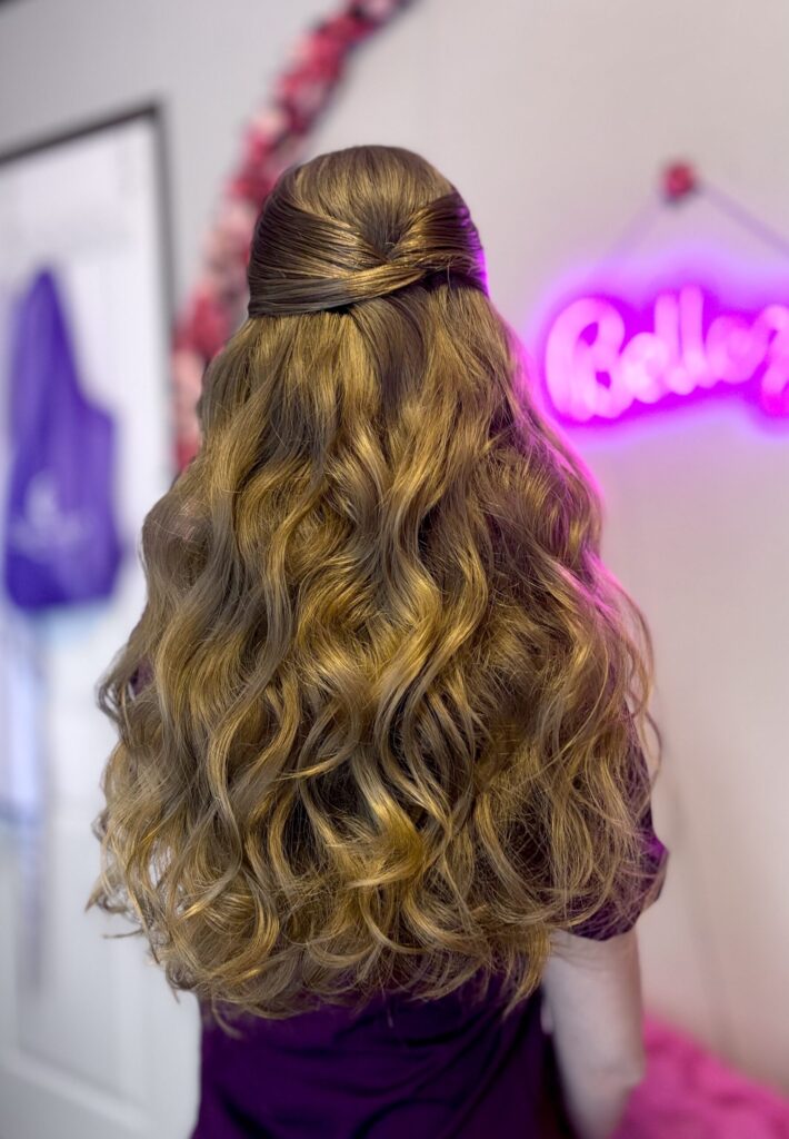 Bridal model with a long blonde half-up half-down curly style. Hair is shiny and glowy with loose curls. Styled by Jaya Ronquillo at the Belleza Styles studio in Ann Arbor Michigan. 