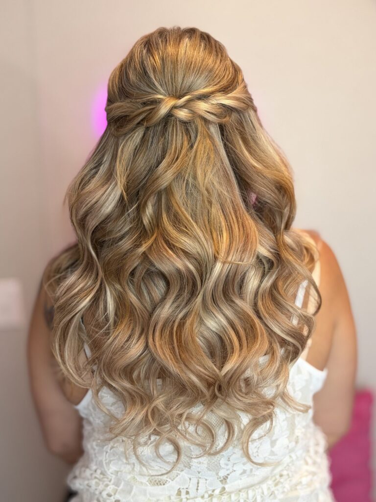 Bridal model with a blonde half-up half-down style with fluffy curls and a braided feature. Styled by Jaya Ronquillo at the Belleza Bridal studio in Ann Arbor Michigan.
