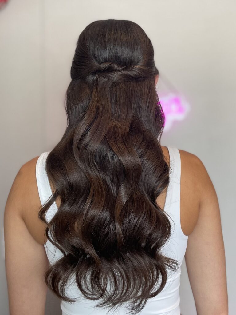 Bridal model with a long black half-up half-down curly style. Hair is shiny and glowy with loose curls. Styled by Jaya Ronquillo at the Belleza Styles studio in Ann Arbor Michigan. 
