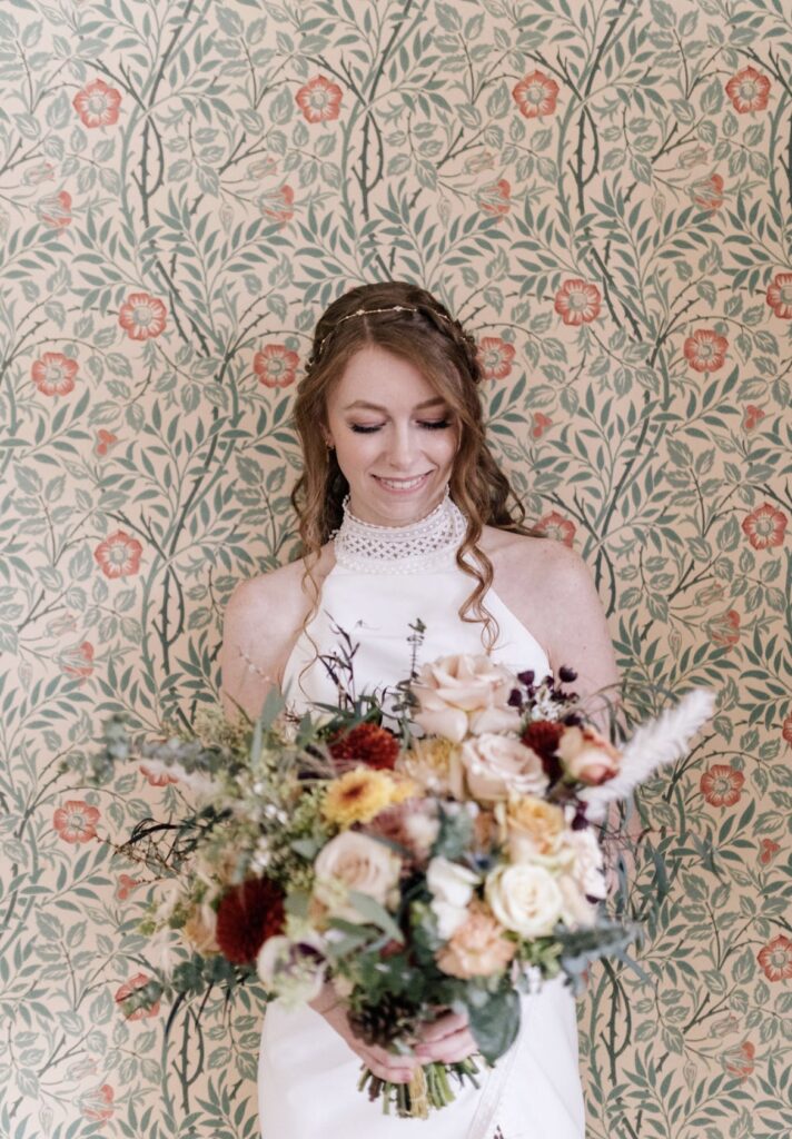 Bride with ginger half-up half-down curls and braided crown.
