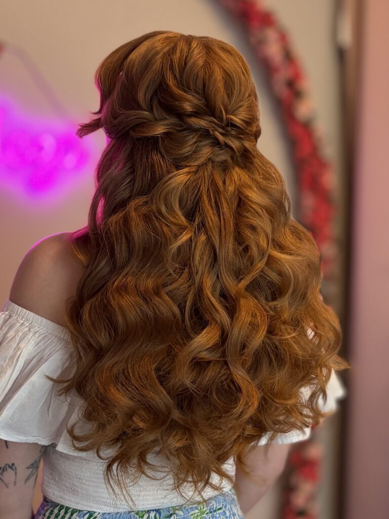 Bridal model with a deep ginger half-up half-down style with fluffy curls and a braided detail in the back. Styled by Jaya Ronquillo at the Belleza Bridal studio in Ann Arbor Michigan.