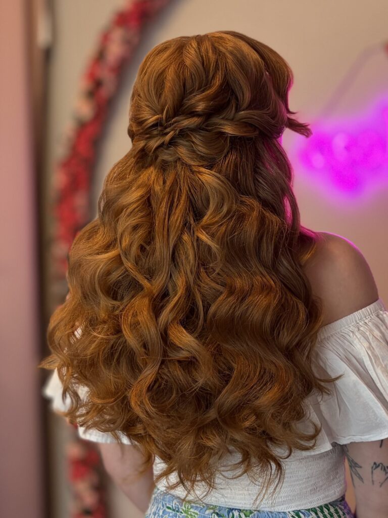 Bridal model with a deep ginger half-up half-down style with fluffy curls and a braided detail in the back. Styled by Jaya Ronquillo at the Belleza Bridal studio in Ann Arbor Michigan.